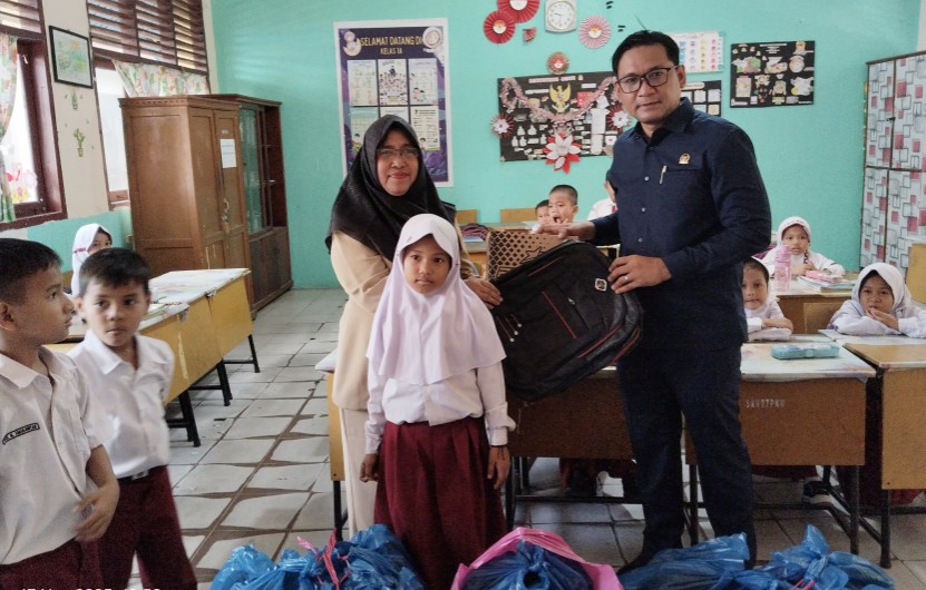 HUT ke-14 DPW Partai NasDem Riau, Aidhil Nur bagi tas sekolah dan sepatu di SDN 027 dan SDN 05 Pekanbaru (foto/Mimi)