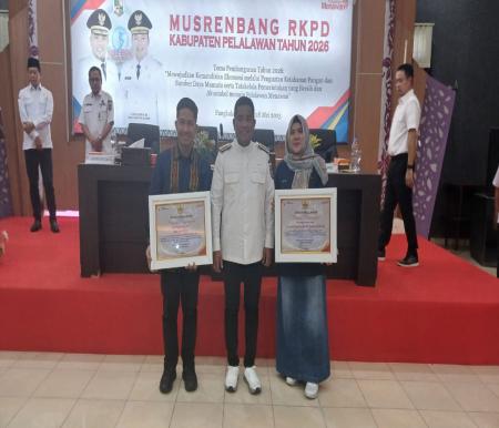 Bupati Pelalawan H Zukri diapit oleh manajemen PT EMP Energi Riau dan EMP Bentu Limited pada penyerahan CSR Award di Kantor Bappeda Pelalawan (foto/Andy)